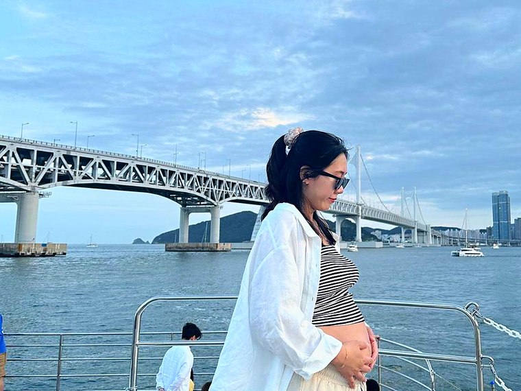 Guest standing on deck with Gwangan Bridge behind