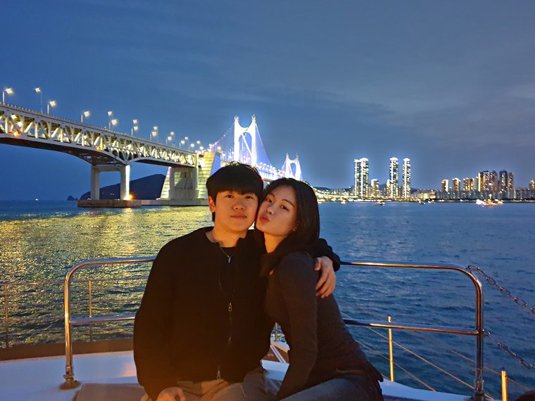 Couple sitting with the night view behind