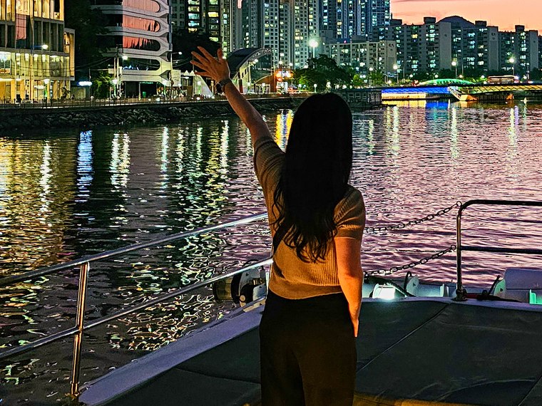 Guest standing on deck at sunset