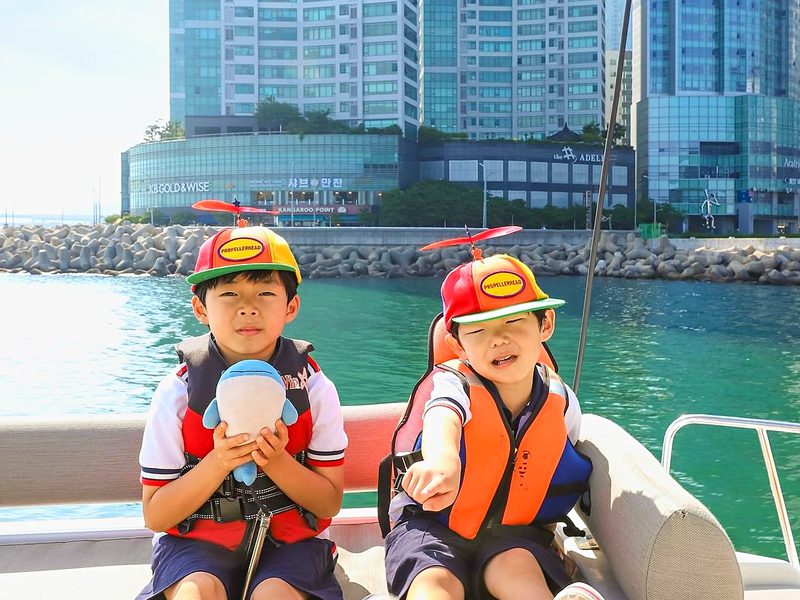 Children in life jackets sitting on a yacht