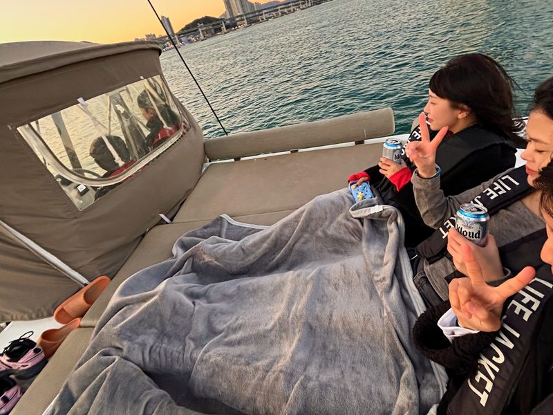 Guest under a blanket on the yacht sofa