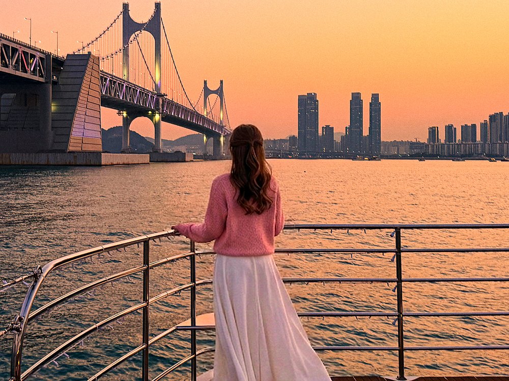 Guest on the cruise looking at Gwangan Bridge at sunset