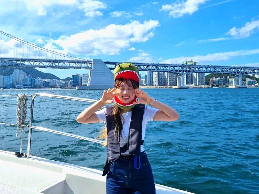 Guest posing on a yacht with Gwangan Bridge behind